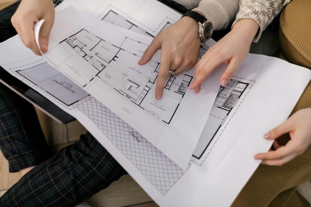 Two people reviewing architectural drawings